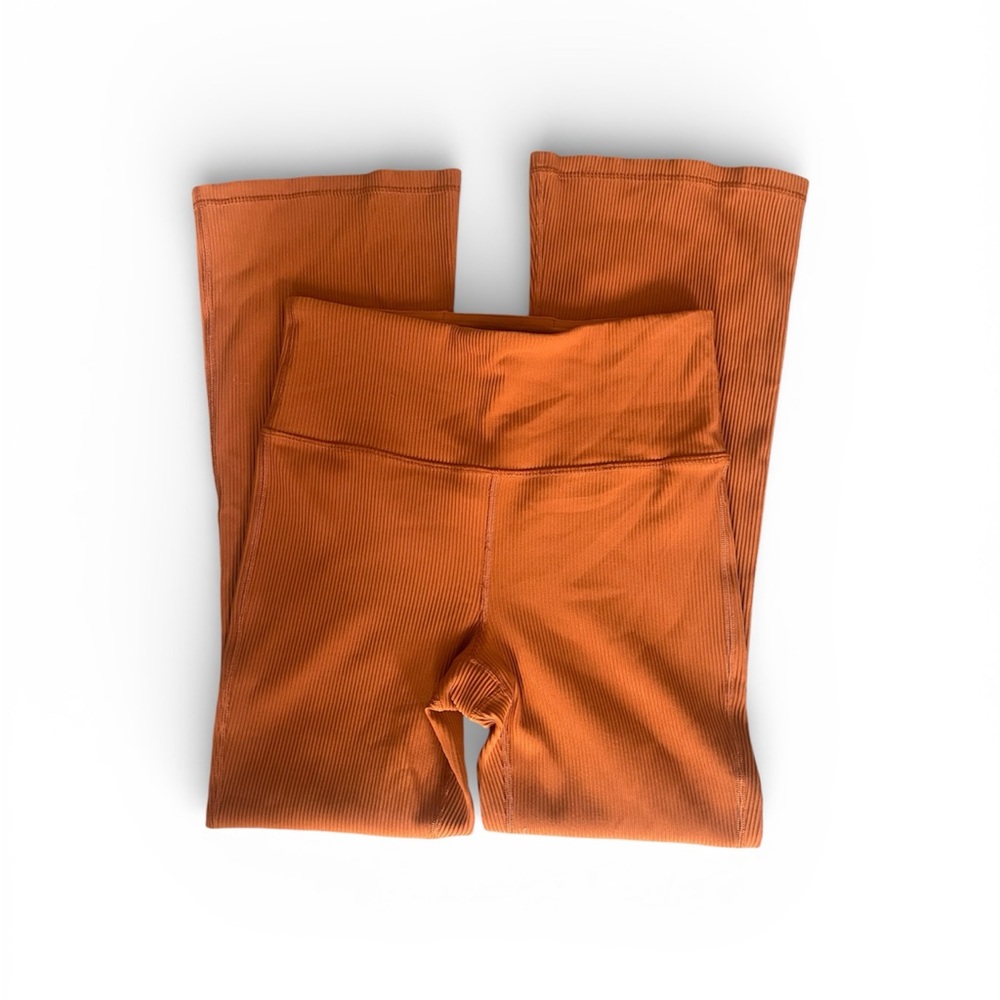 Athleta women’s Leggings in Bold Orange. With flared ankle length bottoms.